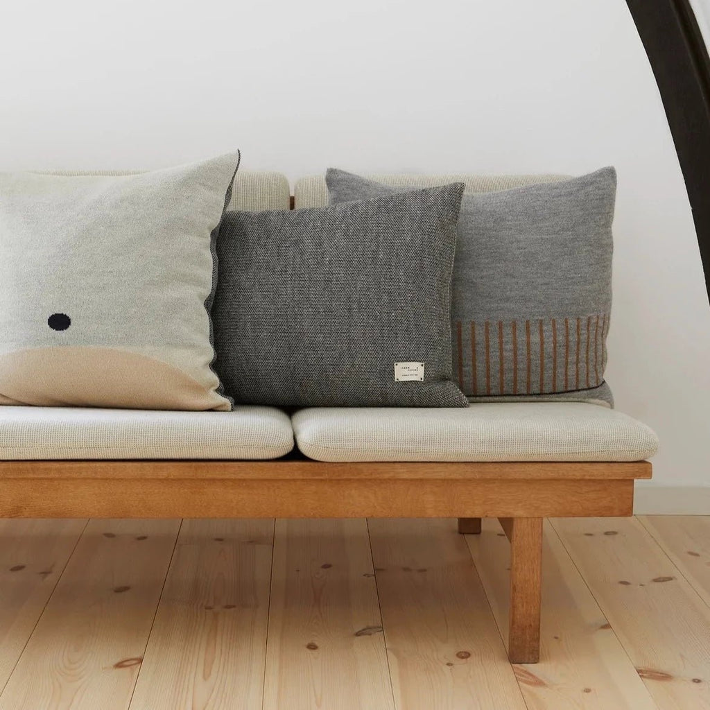 A couch with AYMARA SQUARE CUSHIONS by FORM & REFINE in the Gestalt Haus.