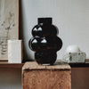 A LOUISE ROE BALLOON VASE 04 sits on top of a wooden table at Gestalt Haus.