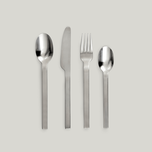 A set of BASE FLATWARE BY PIET BOON utensils on a grey background, exclusively designed for SERAX.