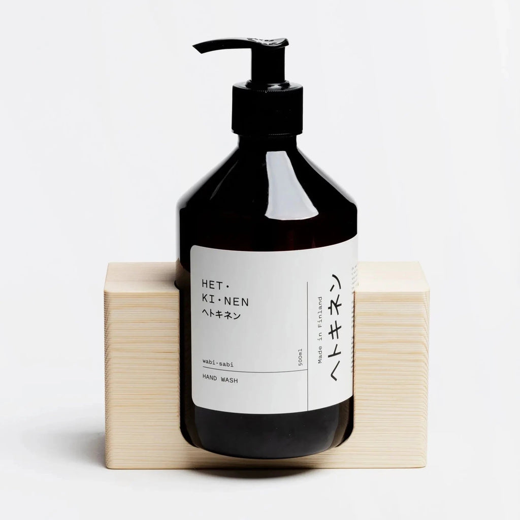 A bottle of HETKINEN hand soap sitting on top of a BLOCK SOAP HOLDER at Gestalt Haus.