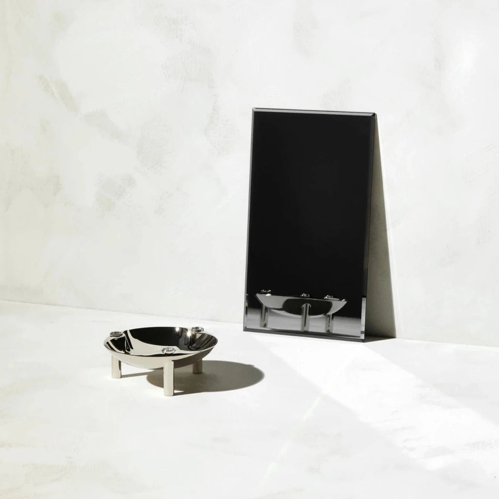A marble floor featuring a mirror and a STOFF NAGEL bowl.