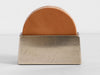 A Studio Henry Wilson wooden coaster holder with coasters crafted with precision, in a tan color.