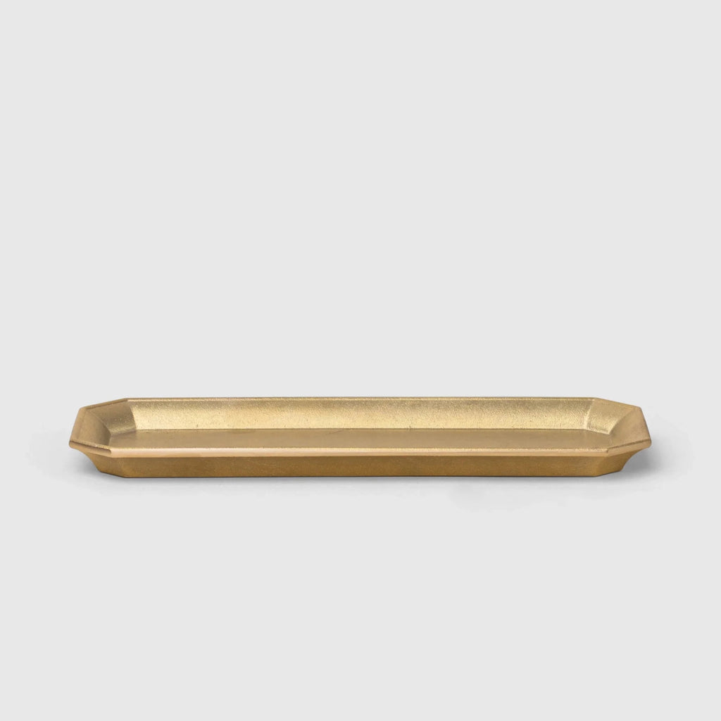 A brass stationery tray on a white background with FUTAGAMI design.