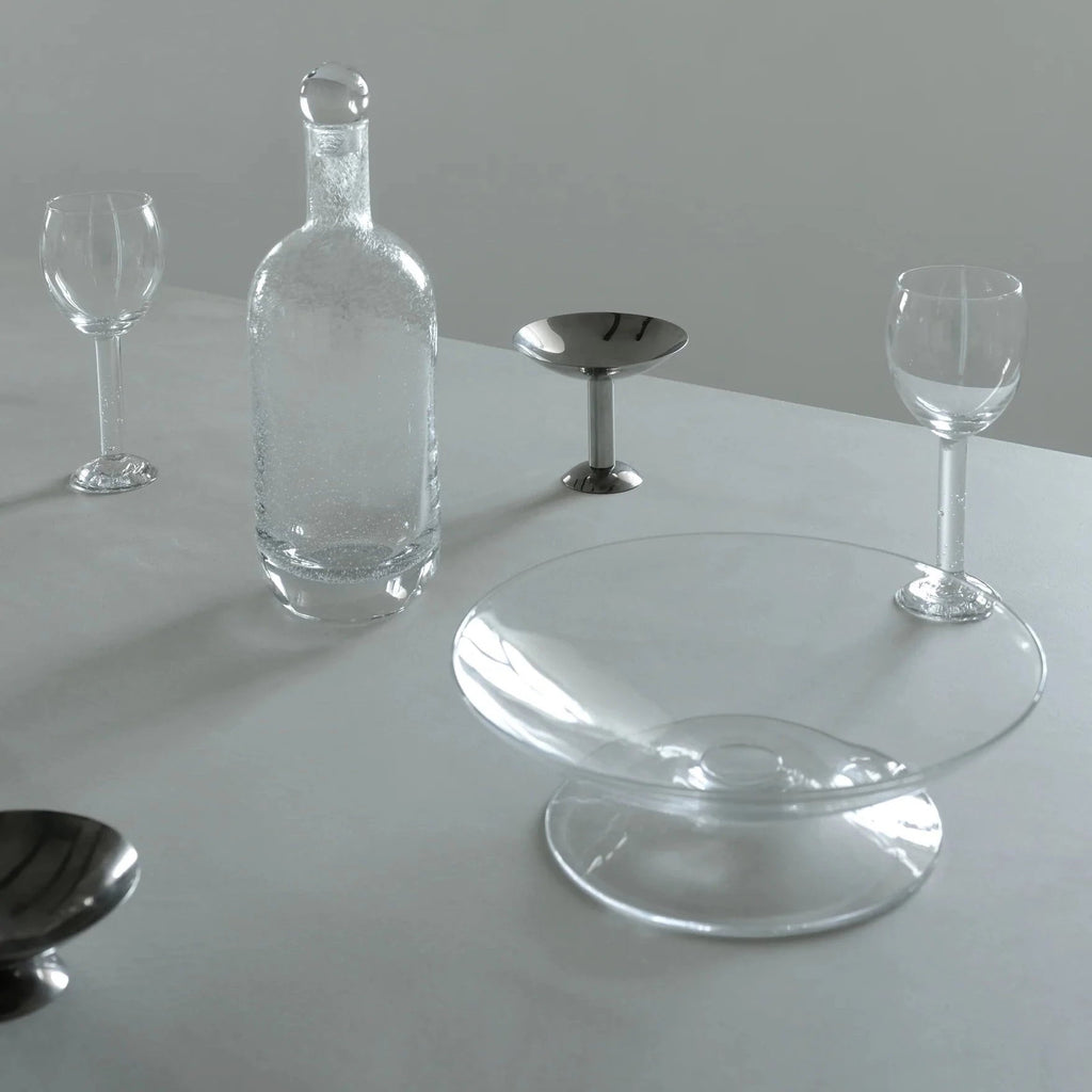 A set of LOUISE ROE BUBBLE GLASS CARAFE and a bottle on a table at Gestalt Haus.