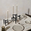 A set of Stoff Nagel candle holders on a Gestalt Haus table.