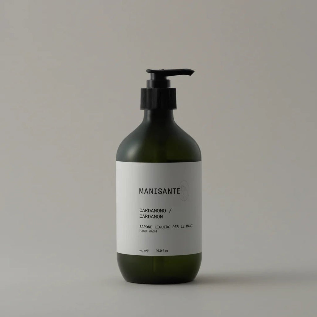 A bottle of MANISANTE CARDAMON HAND WASH on a white background featuring Gestalt Haus logo.