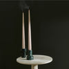 Two COMO TEA LIGHT + TAPER CANDLE HOLDER by AARON PROBYN on a table with smoke and Gestalt Haus.