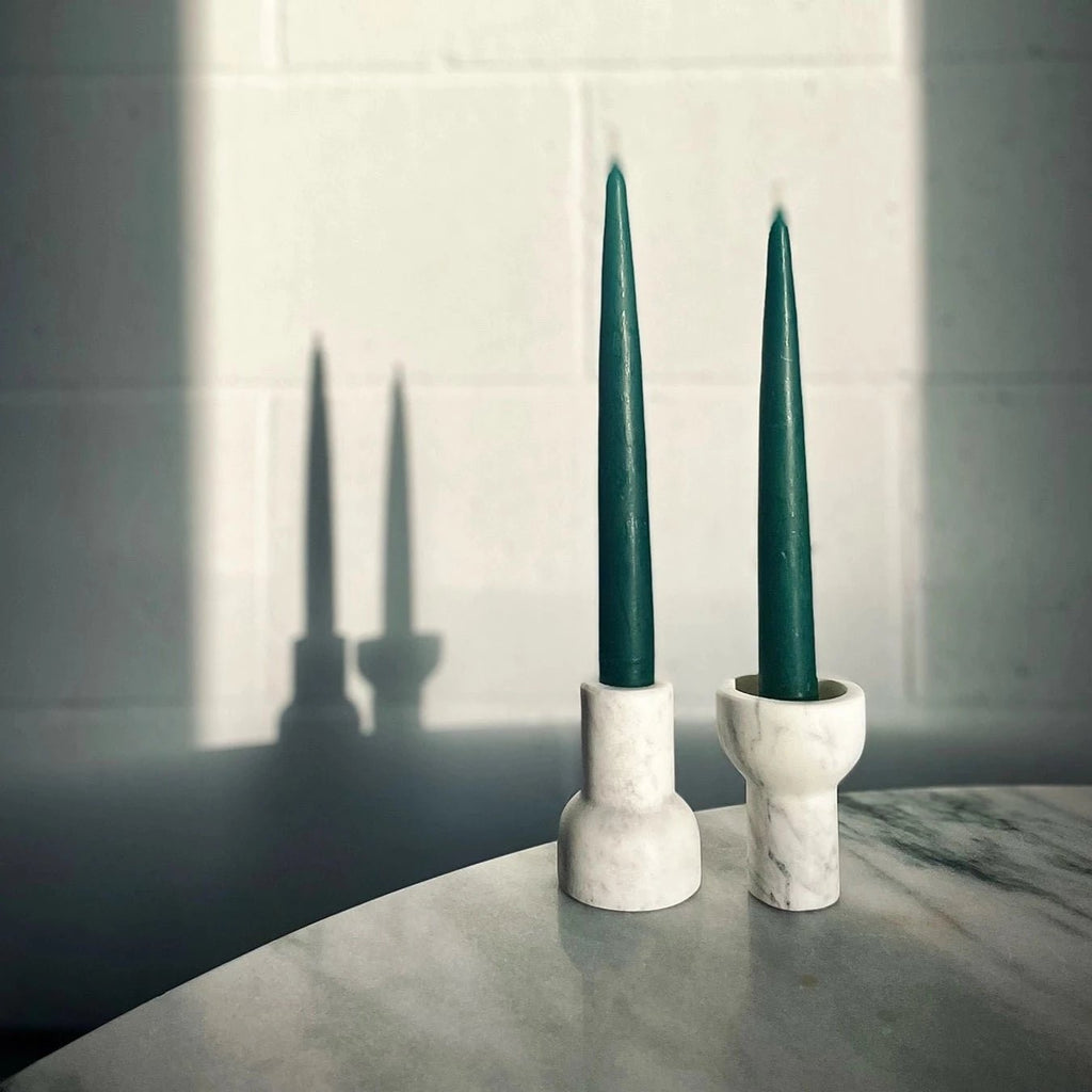 Two COMO TEA LIGHT HOLDERS by AARON PROBYN are sitting on a table in ...