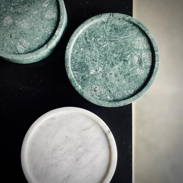 Two green COMO TRAY bowls on a table designed by AARON PROBYN at Gestalt Haus.