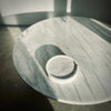 A white marble tray table with an Aaron Probyn ring on it, inspired by the Gestalt Haus design.