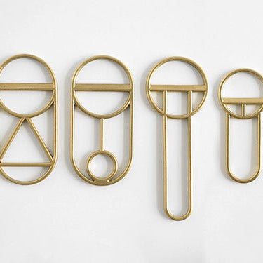 A group of FS OBJECTS CREST BOTTLE OPENERS on a white surface.