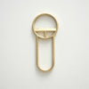 A CREST BOTTLE OPENERS key ring on a white surface by FS OBJECTS.