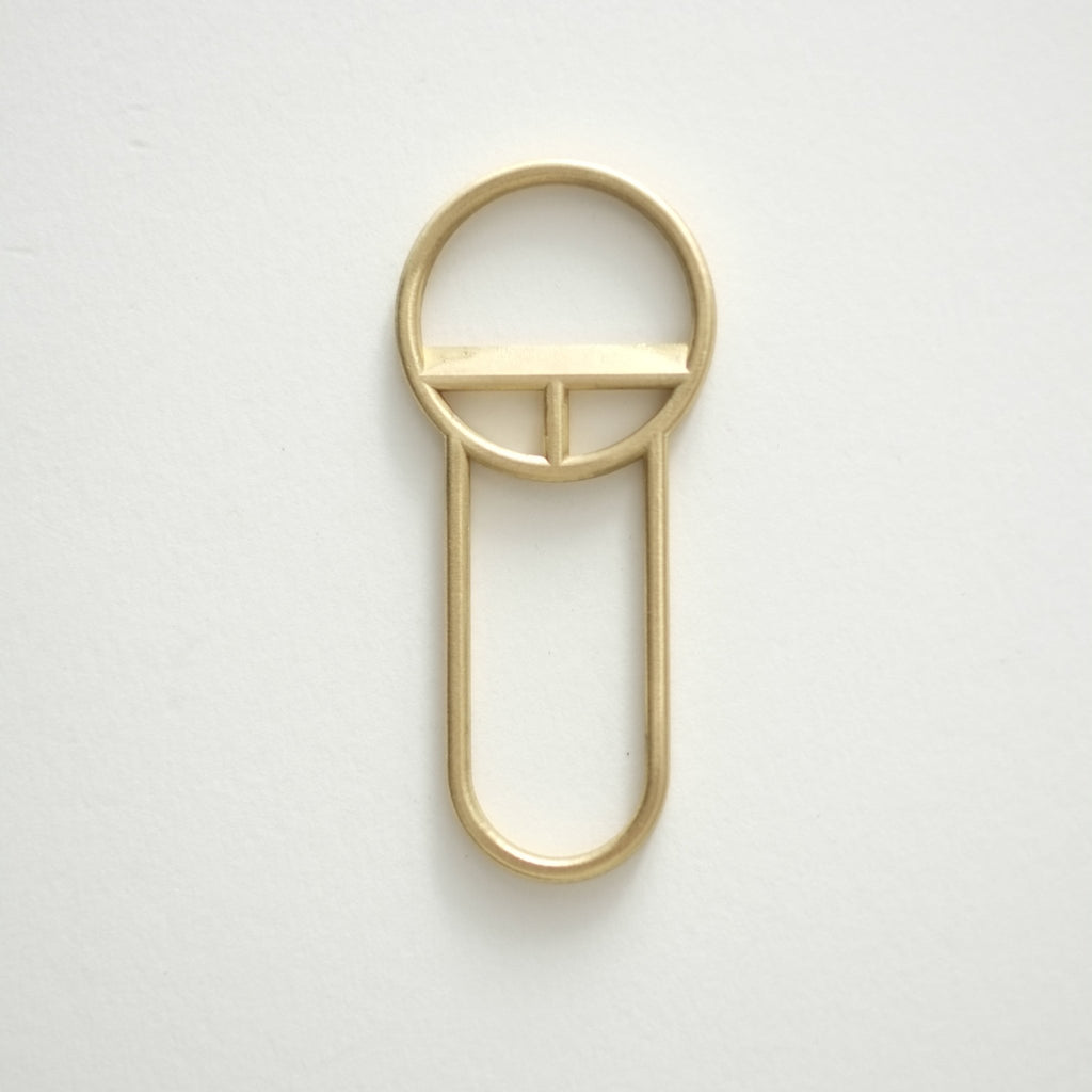 A CREST BOTTLE OPENERS key ring on a white surface by FS OBJECTS.