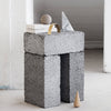 A desk sculpture made of concrete blocks with a vase on top, by Kristina Dam Studio, combining Gestalt and Haus elements.