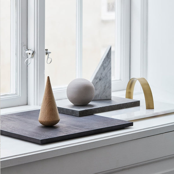 A window sill showcases a collection of Kristina Dam Studio desk sculptures emphasizing the Gestalt Haus aesthetic.