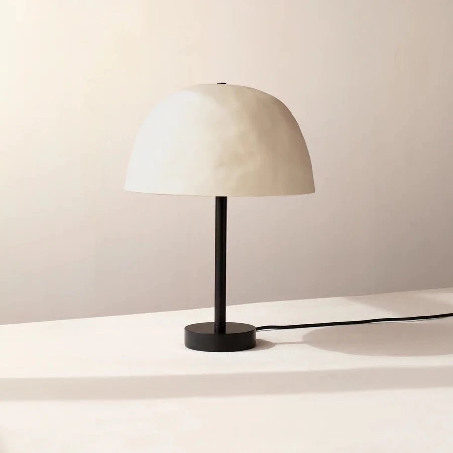 A white table lamp with a white shade by In Common With, exhibiting Gestalt Haus design.