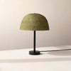 A green dome table lamp by IN COMMON WITH with a Gestalt Haus aesthetic.