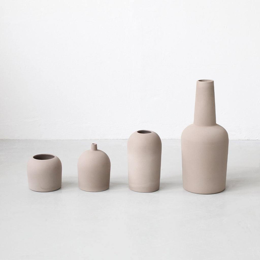 Four DOME VASES from KRISTINA DAM STUDIO are lined up on a white floor in a Gestalt Haus.