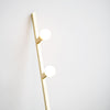 A DOT LINE FLOOR LAMP by LAMBERT ET FILS with two balls on it.