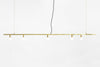A DOT LINE SUSPENSION pendant light by LAMBERT ET FILS hanging from a white wall in Gestalt Haus.