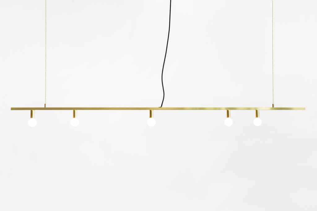 A DOT LINE SUSPENSION pendant light by LAMBERT ET FILS hanging from a white wall in Gestalt Haus.