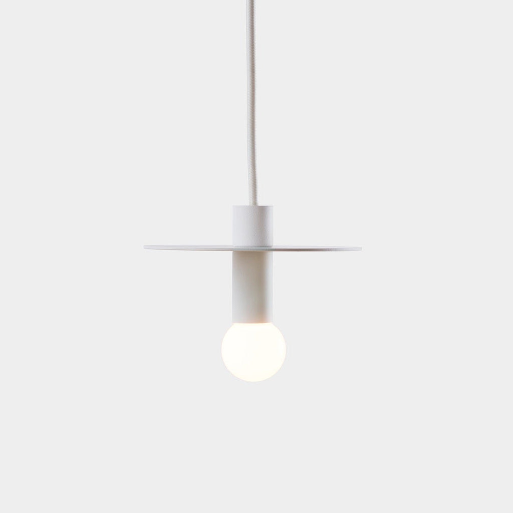 A DOT SUSPENSION pendant light hanging on a white wall by LAMBERT ET FILS in the Gestalt Haus.