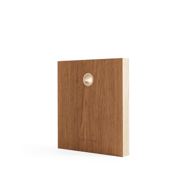 A FRAMA wooden box with a hole in the middle, made from DRY STUDIOS OAK CUTTING BOARDS.