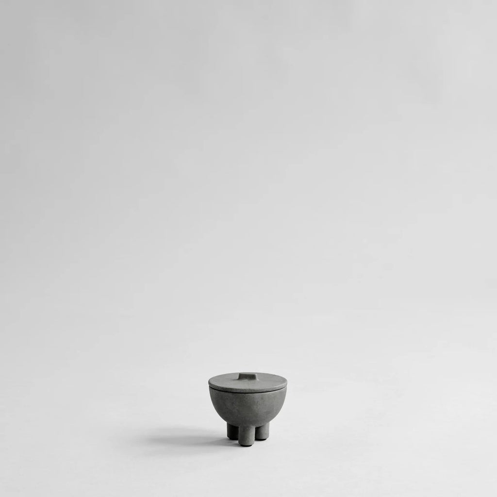 A small MINI DUCK JAR object sitting on a white surface.