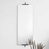 A white wall with a KRISTINA DAM STUDIO EASEL MIRROR and a plant on it in a Gestalt Haus.
