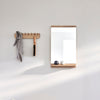 A Gestalt Haus bathroom with an ECHO COAT RACK 40 from FORM & REFINE and a mirror.
