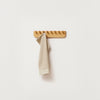 An ECHO COAT RACK 40 by FORM & REFINE with a towel hanging on it, exhibiting a Gestalt Haus theme.