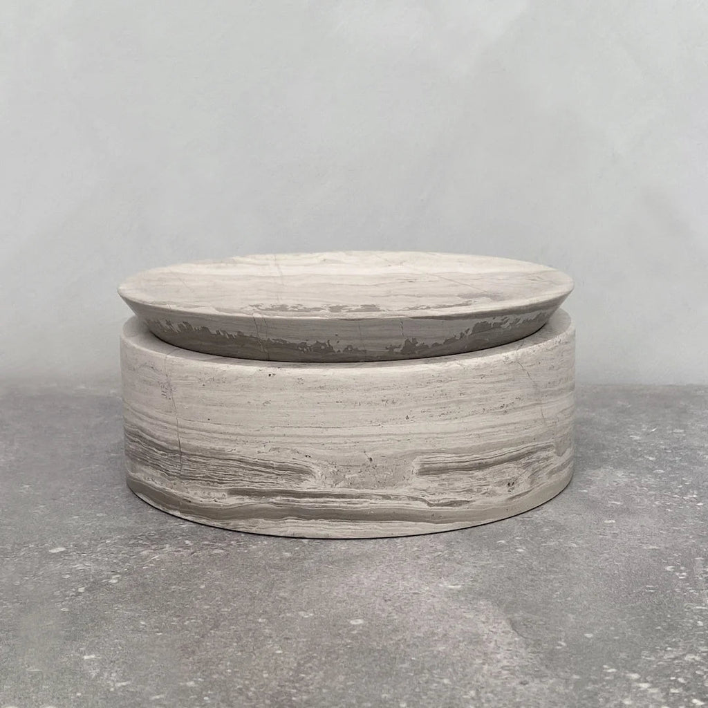 A grey EDO CANISTER sitting on top of a concrete surface at Gestalt Haus.