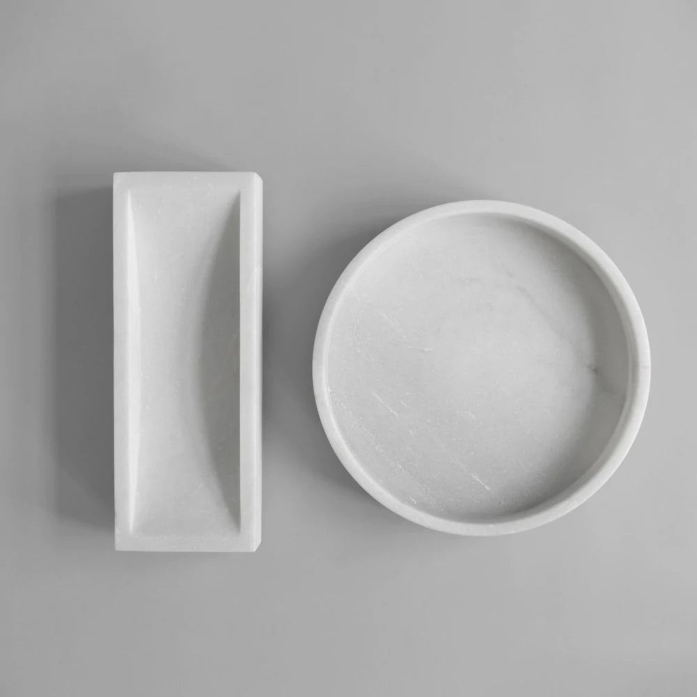 Two FORMALISM TRAY bowls by 101 COPENHAGEN on a grey surface at Gestalt Haus.