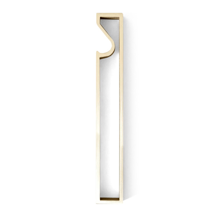 The FUTAGAMI FRAME BOTTLE OPENER with a gold letter "i" on a black background embodies the essence of Gestalt.