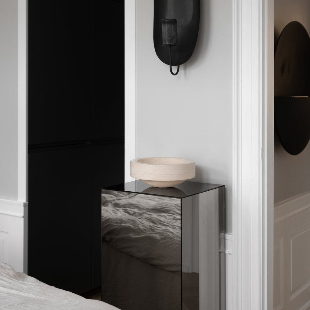 A black and white bedroom with a Gallery Object Bowl bedside table by Louise Roe.