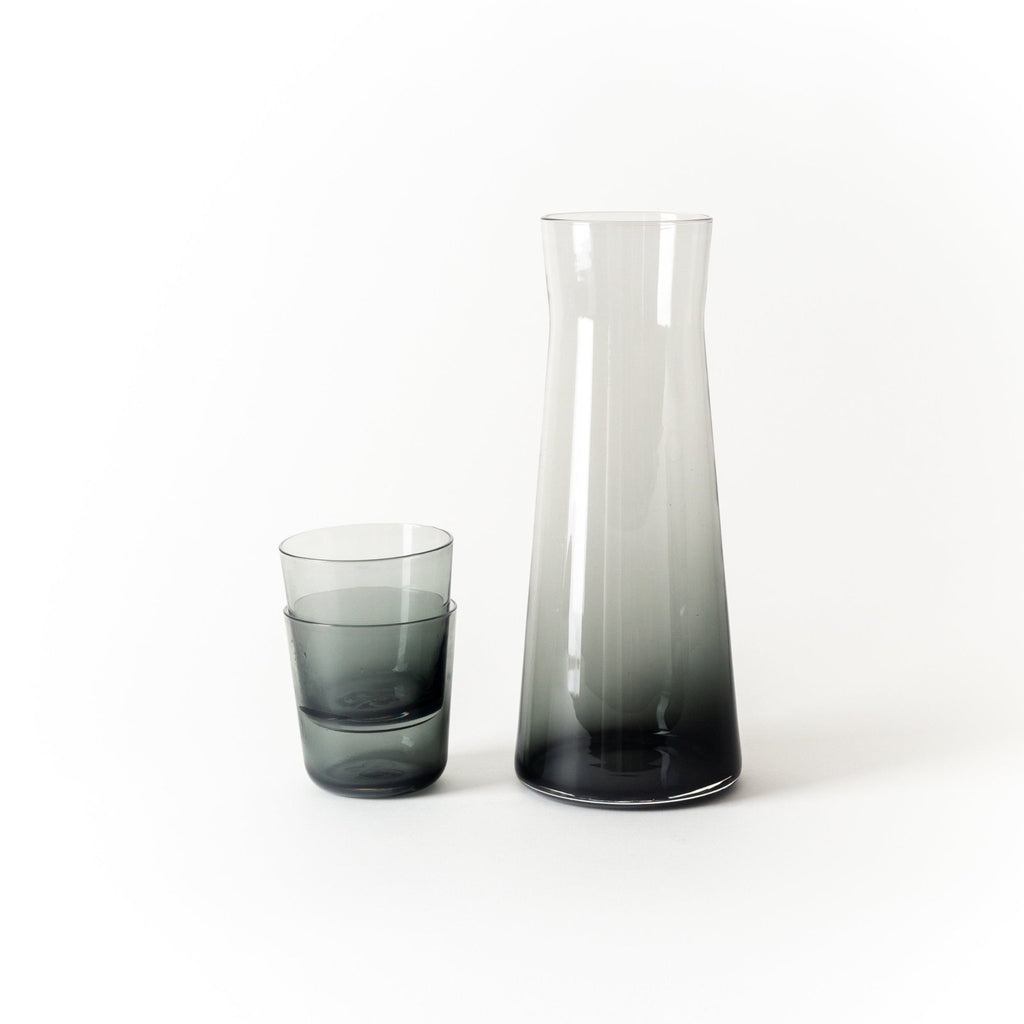 A GLASS CARAFE from GARY BODKER DESIGNS next to a glass at the Gestalt Haus.