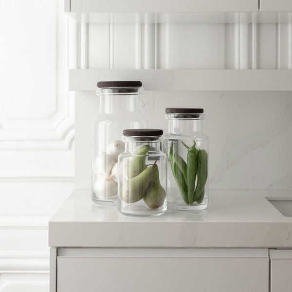 Three Louise Roe glass containers in a kitchen.