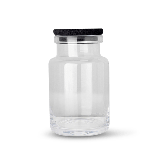 A GLASS CONTAINER with a black lid by LOUISE ROE.