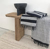 A SERA HELSINKI HAND WOVEN TOWEL COLLECTION towel on a wooden table showcasing Gestalt Haus aesthetic.
