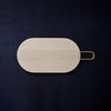 A HEATH MAPLE CUTTING BOARD with a gold handle inspired by Gestalt Haus design.