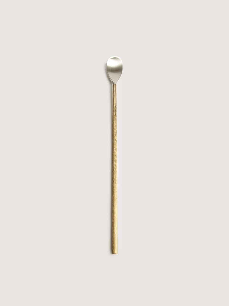 An IHADA MUDDLER SPOON with a gold handle on a white background, designed by FUTAGAMI, embodies the essence of Gestalt Haus.