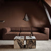 A living room with a brown couch and Gestalt Haus.
