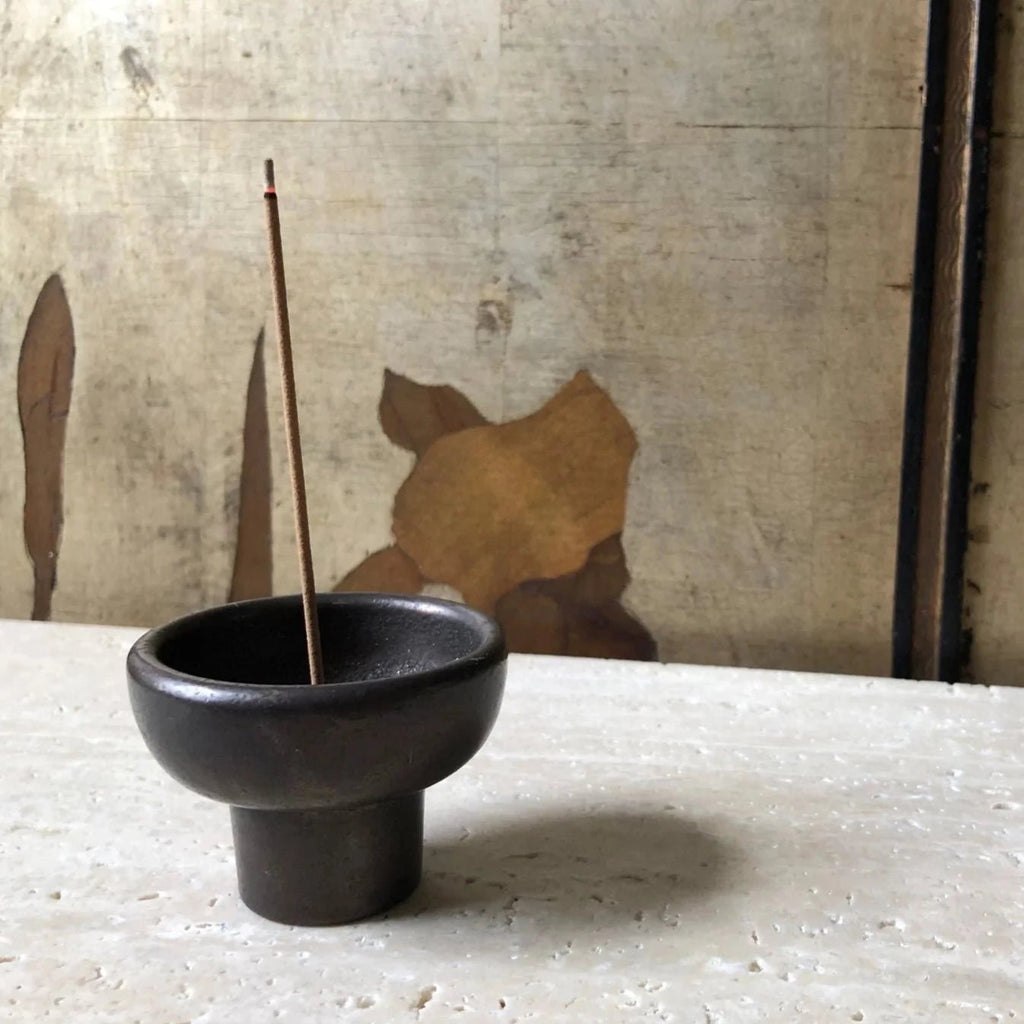 A small Gestalt Haus INCENSE BURNER by STUDIO HENRY WILSON sitting on top of a table.