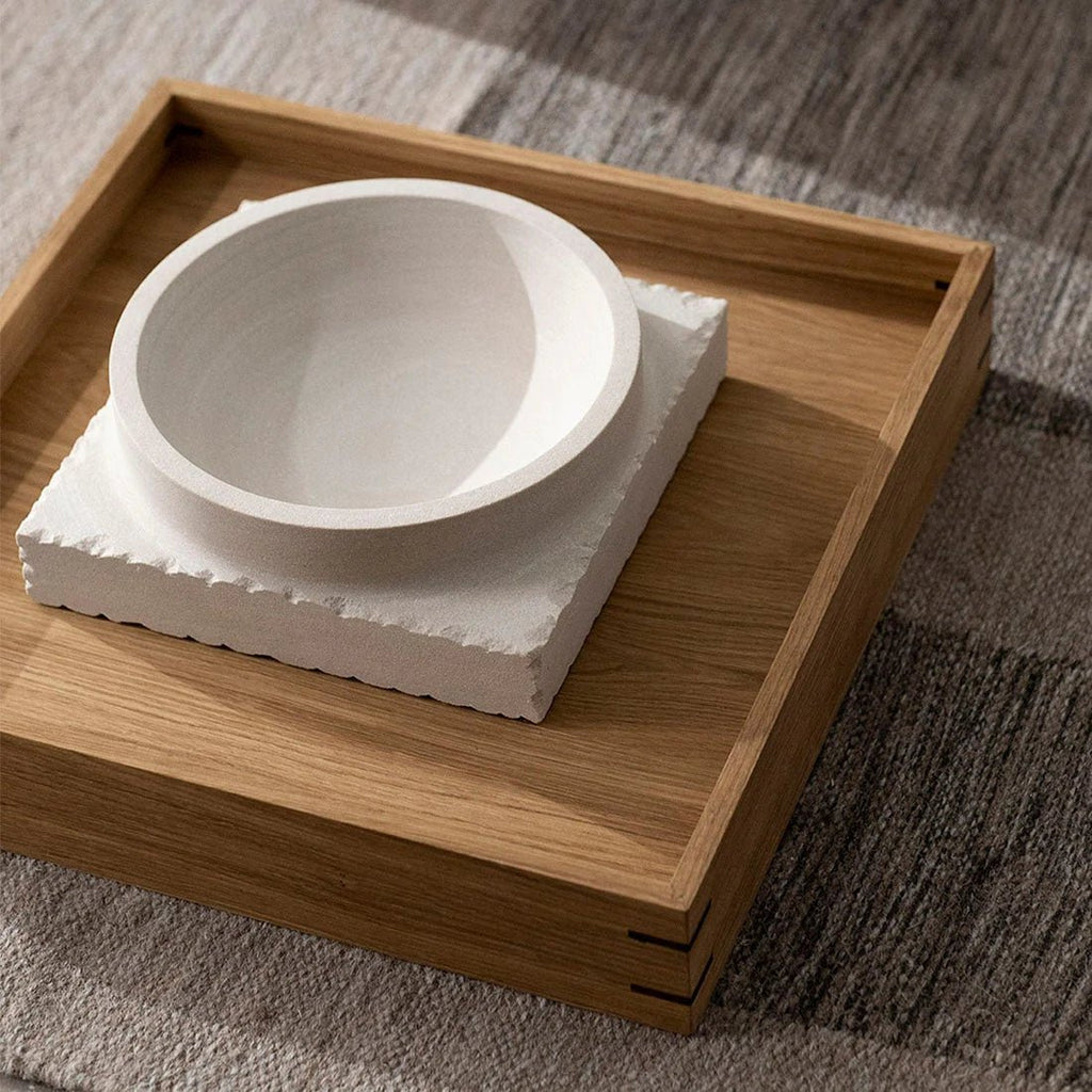 A white bowl sits on a Japanese tray.
