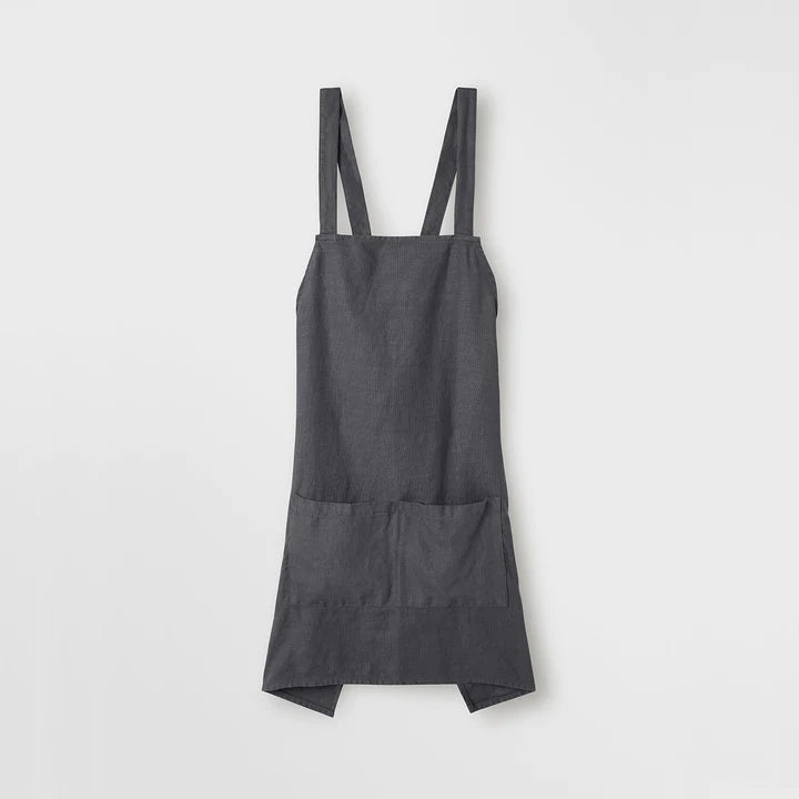 A CULTIVER JUDE LINEN APRON hanging on a white wall in Gestalt Haus.