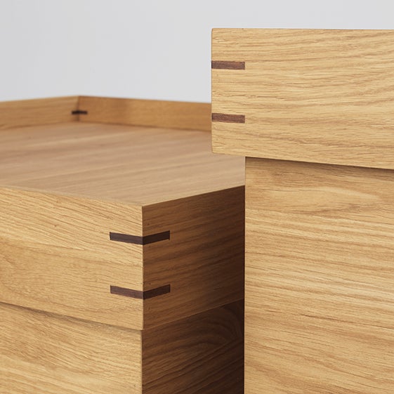 A pair of wooden boxes from KRISTINA DAM STUDIO, inspired by the Gestalt Haus aesthetic, displayed on a white surface.
