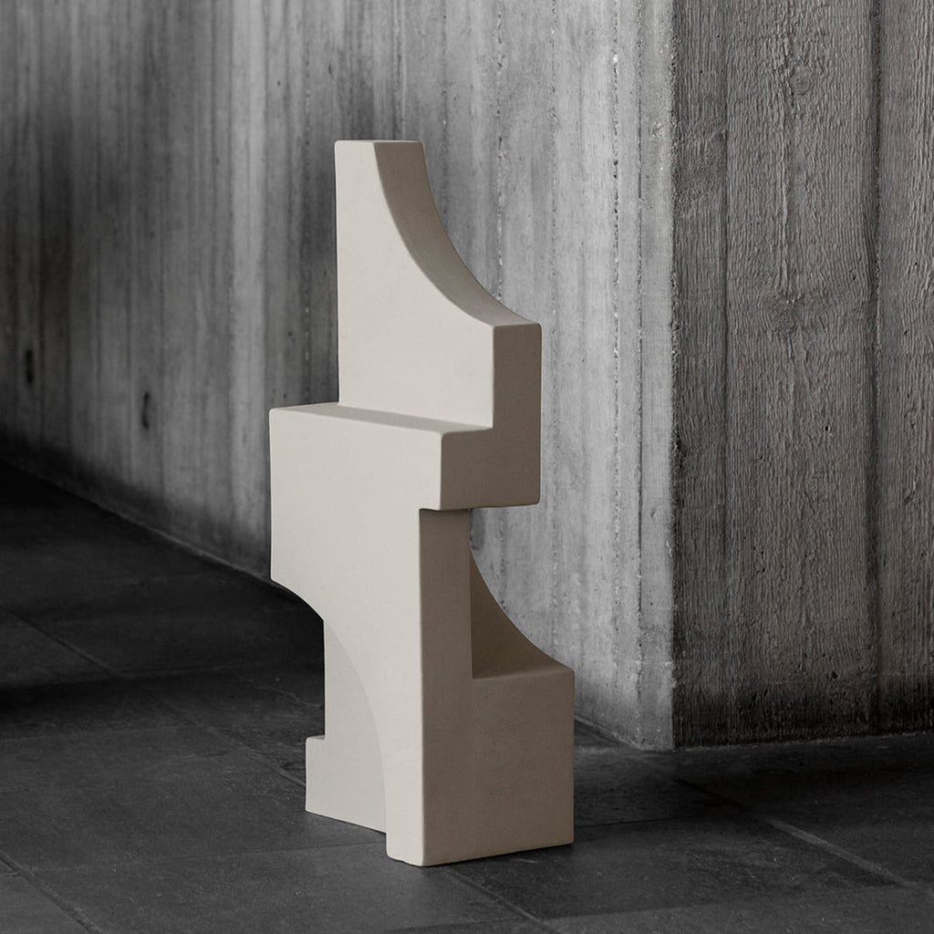 A SERIF SCULPTURE from KRISTINA Dam Studio sits in front of a concrete wall at Gestalt Haus.