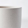 A SETOMONO CUP by KRISTINA DAM STUDIO on a white surface showcasing Gestalt Haus aesthetics.