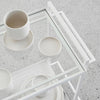 A white SETOMONO CONTAINER with cups and plates on it by Kristina Dam Studio, embracing the principles of Gestalt Haus.