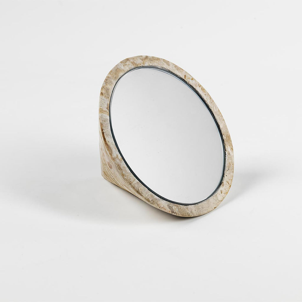 A SPINNING TOP MIRROR by KRISTINA DAM STUDIO adding an element of Gestalt to a white surface.